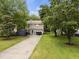Aerial view showcases a two-story home with a spacious backyard and driveway at 4104 Panther Creek Pkwy, Durham, NC 27704