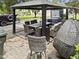 Inviting backyard patio featuring a gazebo with dining set and comfortable lounge seating for outdoor enjoyment at 4104 Panther Creek Pkwy, Durham, NC 27704