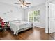Bright bedroom featuring hardwood floors, a ceiling fan, and a window with natural light at 4104 Panther Creek Pkwy, Durham, NC 27704