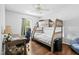 Bedroom with a bunk bed, desk, ceiling fan, hardwood floors, and natural light from the window at 4104 Panther Creek Pkwy, Durham, NC 27704