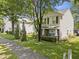 Charming two-story home features a well-manicured lawn and a welcoming front porch with brick and stone accents at 4104 Panther Creek Pkwy, Durham, NC 27704
