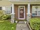 Charming front entrance featuring a brick facade, decorative plants, and a welcoming front door at 4104 Panther Creek Pkwy, Durham, NC 27704