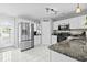 Bright kitchen features stainless steel appliances, white cabinets, granite countertops, and a stylish backsplash at 4104 Panther Creek Pkwy, Durham, NC 27704