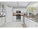 Bright kitchen features stainless steel appliances, white cabinets, granite countertops, and a stylish backsplash at 4104 Panther Creek Pkwy, Durham, NC 27704