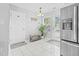 Bright kitchen features stainless steel appliances, white cabinets, granite countertops, and a stylish backsplash at 4104 Panther Creek Pkwy, Durham, NC 27704