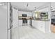 Bright kitchen features stainless steel appliances, white cabinets, granite countertops, and a stylish backsplash at 4104 Panther Creek Pkwy, Durham, NC 27704