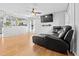 Open living room boasts hardwood floors, a ceiling fan, and seamless flow to the adjacent kitchen with breakfast bar at 4104 Panther Creek Pkwy, Durham, NC 27704