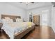 Spacious main bedroom featuring a wooden bed frame, hardwood floors, and ample storage at 4104 Panther Creek Pkwy, Durham, NC 27704