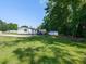 Expansive backyard with green grass, a basketball hoop, and mature shade trees at 4125 Brushy Ridge Dr, Holly Springs, NC 27540