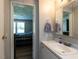 Bathroom featuring white vanity, wood-look floors, and a view into the bedroom at 4125 Brushy Ridge Dr, Holly Springs, NC 27540