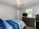Bedroom with a ceiling fan, wood-look flooring, and a window offering natural light at 4125 Brushy Ridge Dr, Holly Springs, NC 27540