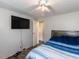 Cozy bedroom featuring a bed with blue striped bedding and wood-look floors at 4125 Brushy Ridge Dr, Holly Springs, NC 27540