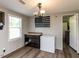 Dining room featuring wood-look floors, modern light fixture, and plenty of light at 4125 Brushy Ridge Dr, Holly Springs, NC 27540