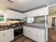 Well-lit kitchen with stainless steel appliances, white cabinets, and an open layout at 4125 Brushy Ridge Dr, Holly Springs, NC 27540