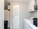 Well-equipped laundry room with washer and dryer, white cabinets, and storage space at 4125 Brushy Ridge Dr, Holly Springs, NC 27540