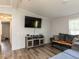 Modern living room boasts vinyl flooring, large screen TV, and comfortable seating at 4125 Brushy Ridge Dr, Holly Springs, NC 27540