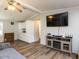 Living room with vinyl floors, large screen tv, and ceiling fan at 4125 Brushy Ridge Dr, Holly Springs, NC 27540