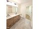 Bathroom with double sink vanity, tile flooring, and a walk in closet at 4206 Camden Woods Ct, Raleigh, NC 27612