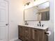 Bathroom featuring a double sink vanity with framed mirror and modern lighting at 4206 Camden Woods Ct, Raleigh, NC 27612