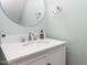 Clean bathroom with a white vanity, modern fixtures, and a round mirror at 4206 Camden Woods Ct, Raleigh, NC 27612