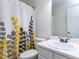 Bright bathroom with a single sink, a patterned shower curtain, and a clean, functional space at 4206 Camden Woods Ct, Raleigh, NC 27612