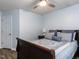 Comfortable bedroom featuring a ceiling fan, window, and a well-appointed bed at 4206 Camden Woods Ct, Raleigh, NC 27612