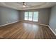 Spacious bedroom features hardwood floors, a tray ceiling, and plenty of natural light at 4206 Camden Woods Ct, Raleigh, NC 27612