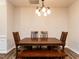 Traditional dining room featuring a wooden table and chairs, complemented by new floors and a stylish light fixture at 4206 Camden Woods Ct, Raleigh, NC 27612