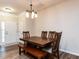 Traditional dining room featuring a wooden table and chairs, complemented by new floors and a stylish light fixture at 4206 Camden Woods Ct, Raleigh, NC 27612