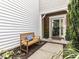 Inviting front porch with a wooden bench and landscaping, offering a warm welcome to the home at 4206 Camden Woods Ct, Raleigh, NC 27612
