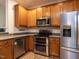 Well-equipped kitchen with stainless steel appliances, wood cabinets, and a double oven for culinary enthusiasts at 4206 Camden Woods Ct, Raleigh, NC 27612