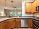 Functional kitchen with modern appliances, wood cabinets, and an open design that seamlessly connects to the living area at 4206 Camden Woods Ct, Raleigh, NC 27612