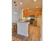 Kitchen with stainless steel appliances, wood cabinets, breakfast bar and wood floors at 4206 Camden Woods Ct, Raleigh, NC 27612