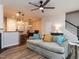 Open-concept living room featuring wood floors, ceiling fan, and a comfortable sofa at 4206 Camden Woods Ct, Raleigh, NC 27612