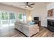 Cozy living room with new floors, a fireplace, sliding glass doors, and modern decor for relaxation and entertainment at 4206 Camden Woods Ct, Raleigh, NC 27612