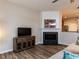 Stylish living room featuring a modern fireplace, new flooring, and a cozy atmosphere for relaxation and entertainment at 4206 Camden Woods Ct, Raleigh, NC 27612