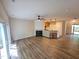 Open-concept living room with fireplace, wood floors and breakfast bar to kitchen at 4206 Camden Woods Ct, Raleigh, NC 27612