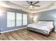 Spacious main bedroom with tray ceiling, fan, and large windows at 4206 Camden Woods Ct, Raleigh, NC 27612