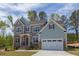 Charming two-story home with a two-car garage, stone accents, and a landscaped front yard at 45 Little Gem Ln, Fuquay Varina, NC 27526