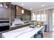Spacious kitchen featuring an island with white countertops, stainless steel appliances, and wooden cabinets at 45 Little Gem Ln, Fuquay Varina, NC 27526