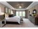 Relaxing main bedroom features neutral colors, ceiling fan, large window and a comfortable bed at 45 Little Gem Ln, Fuquay Varina, NC 27526