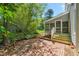 The backyard features a brick patio and a screened porch, perfect for enjoying the outdoors at 4500 Lancashire Dr, Raleigh, NC 27613