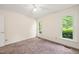 Bedroom with light walls, carpet, ceiling fan, two windows that provide ample natural light at 4500 Lancashire Dr, Raleigh, NC 27613