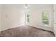 Bedroom with neutral walls, carpeted floor, ceiling fan, and natural light from two windows at 4500 Lancashire Dr, Raleigh, NC 27613