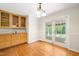Dining room with hardwood floors, built-in cabinet and French doors leading to screened porch at 4500 Lancashire Dr, Raleigh, NC 27613