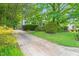 Home featuring driveway access, mature landscaping, and partial front exterior at 4500 Lancashire Dr, Raleigh, NC 27613