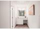 Bright hall bathroom featuring a vanity, sink, and framed mirror at 4500 Lancashire Dr, Raleigh, NC 27613