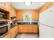 Kitchen with white appliances, granite countertops, and wooden cabinets at 4500 Lancashire Dr, Raleigh, NC 27613