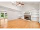Spacious living room with vaulted ceilings, hardwood floors, and fireplace with built-in shelving at 4500 Lancashire Dr, Raleigh, NC 27613