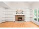 Bright living room featuring fireplace with built-in shelving and a sun-drenched window at 4500 Lancashire Dr, Raleigh, NC 27613